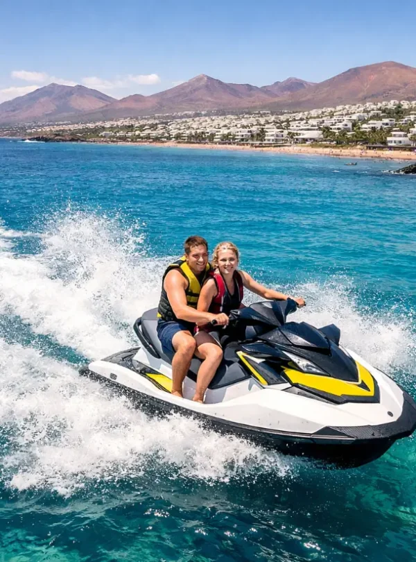 Jet ski Lanzarote aerial view tourists riding jet ski in the Atlantic Ocean near Puerto del Carmen volcanic coastline
