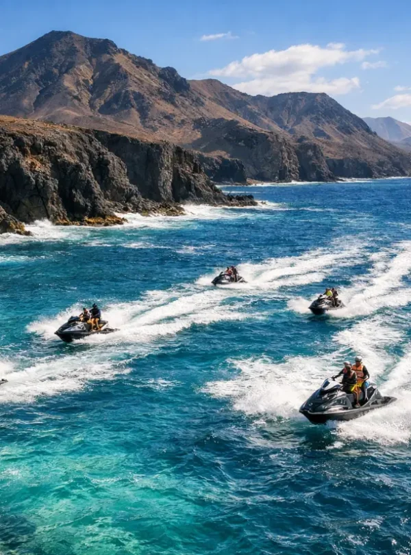 Jet ski tour Lanzarote aerial drone view of jet skis riding across the Atlantic Ocean with volcanic landscape