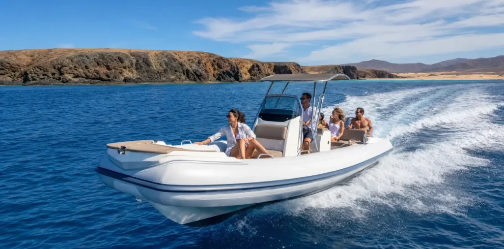 Private speedboat charter cruising along the volcanic coast of Lanzarote