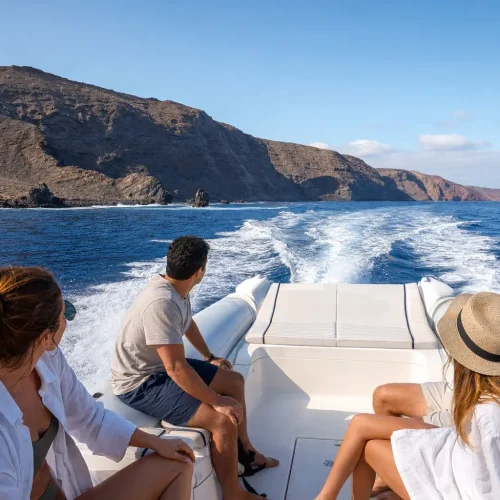 Private speedboat cruising along the volcanic coast of Lanzarote
