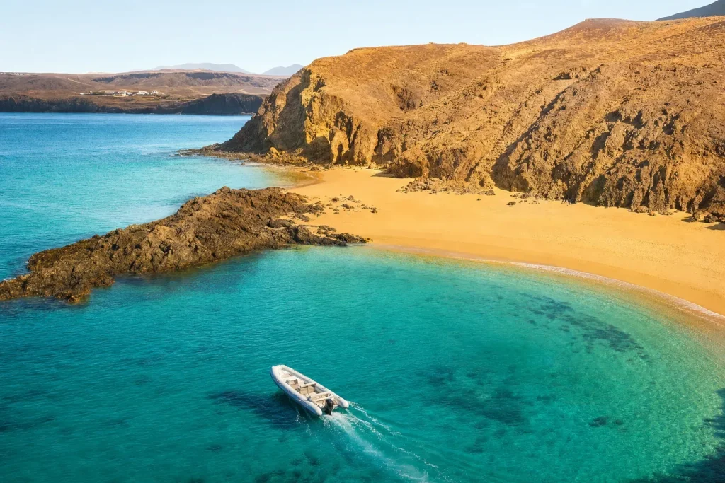 Private boat anchored in turquoise water at Papagayo Beaches Lanzarote