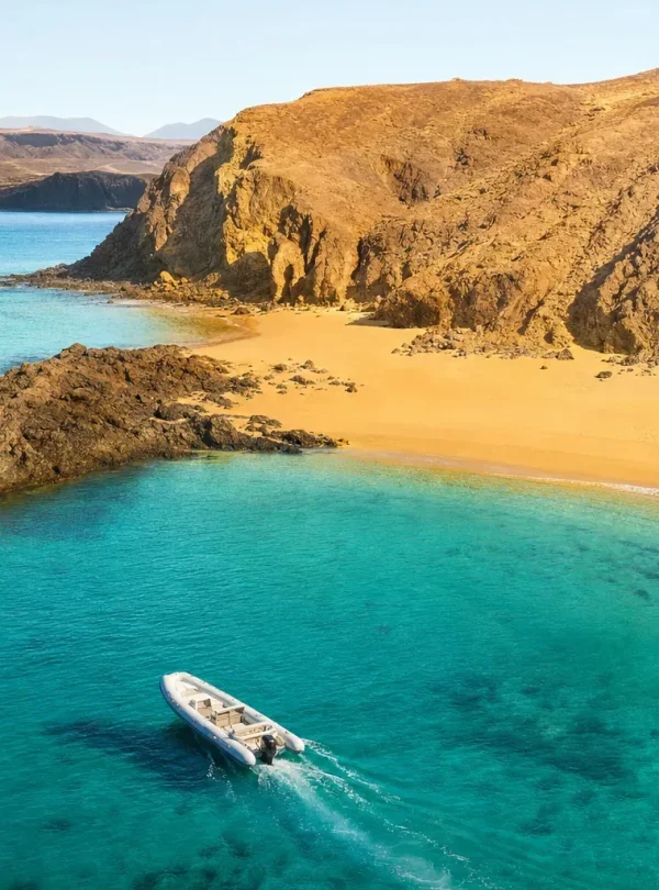 Private boat anchored in turquoise water at Papagayo Beaches Lanzarote