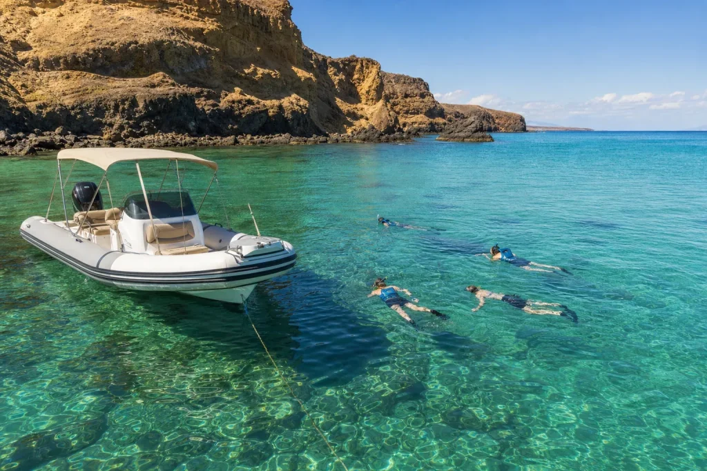 Guests snorkelling from a private boat near Papagayo Beaches in Lanzarote