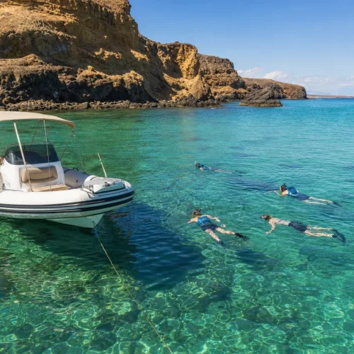 Guests snorkelling from a private boat near Papagayo Beaches in Lanzarote