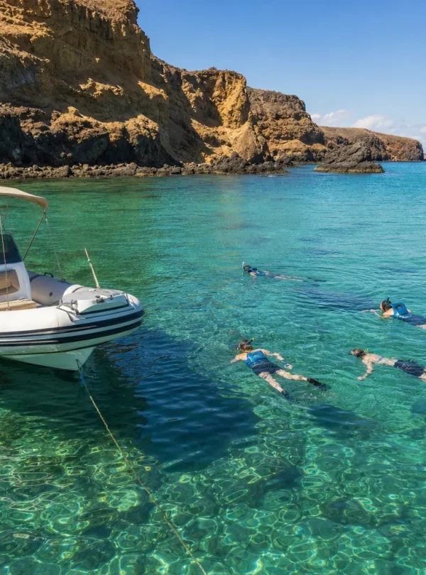 Guests snorkelling from a private boat near Papagayo Beaches in Lanzarote
