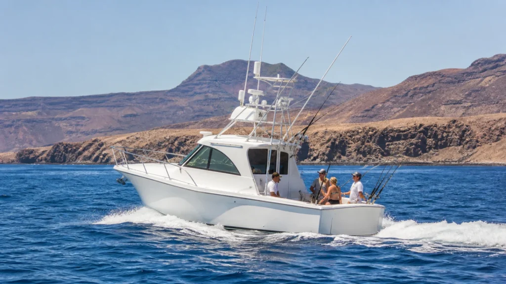 White sport-fishing boat on the Atlantic near Lanzarote volcanic coast