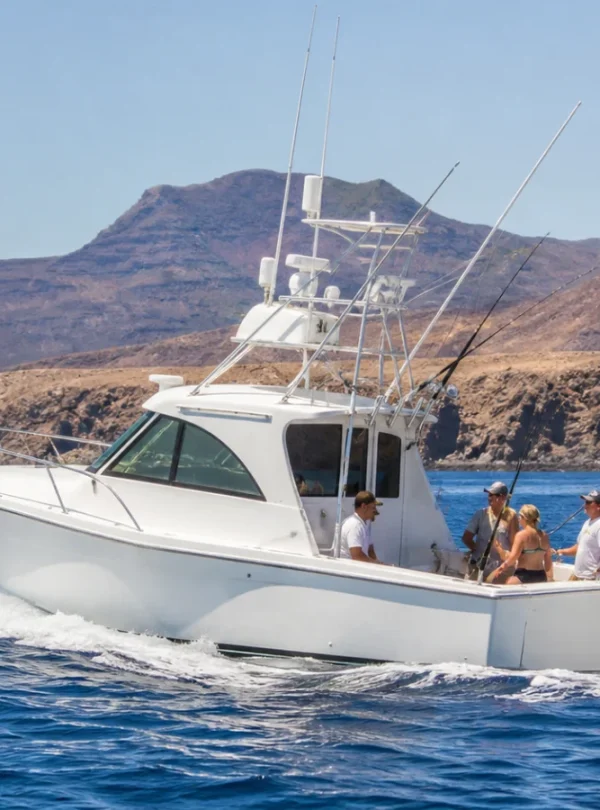 White sport-fishing boat on the Atlantic near Lanzarote volcanic coast